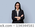 Confident successful middle-aged businesswoman in black jacket on light studio background 134344581