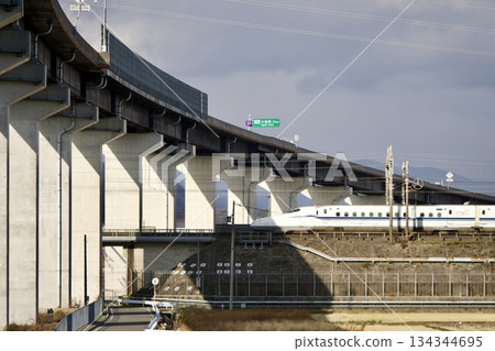 The Tokaido Shinkansen running under the elevated expressway – Ogaki City, Gifu Prefecture 134344695