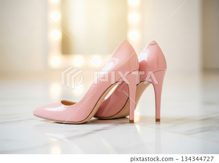 Close-up of pastel pink shiny pumps and stage lighting 134344727