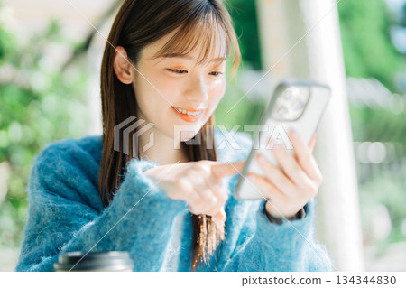 在露台上看智慧型手機的女人 134344830