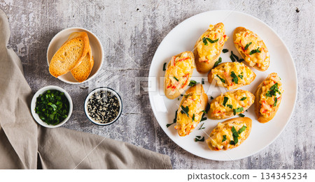 Baked sandwiches with crab salad and greens on a plate on the table top view web banner Baked sandwiches with crab salad and greens on a plate on the table top view web banner 134345234