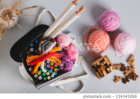 A tote bag with craft and leisure items on a table top view A tote bag with craft and leisure items on a table top view 134345269