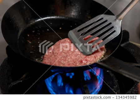 Cooking process of grilling hamburger steak in a frying pan 134345982