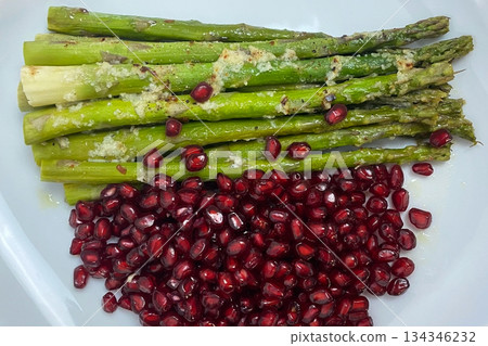 Roasted Asparagus with Pomegranate Seeds on a White Plate 134346232
