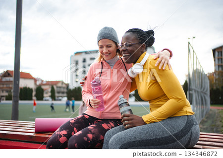 Diverse women friends resting after outdoor workout Diverse women friends resting after outdoor workout 134346872