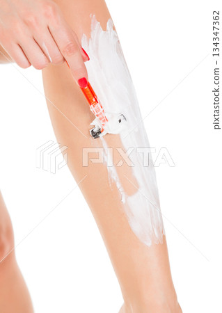 Woman shaving her legs, isolated on white background Woman shaving her legs, isolated on white background 134347362