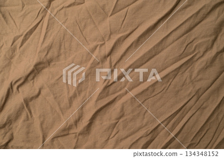 Close-up of light brown fold plain fabric.Light brown fold plain fabric texture and background. 134348152