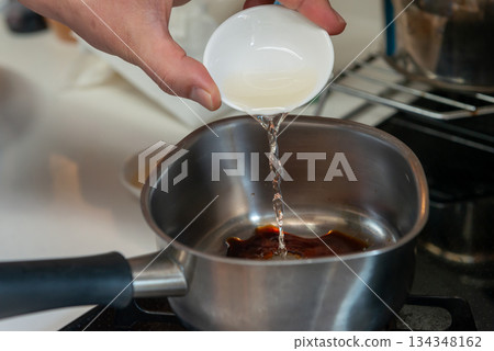 Close-up of cooking process adding seasonings to a pot 134348162