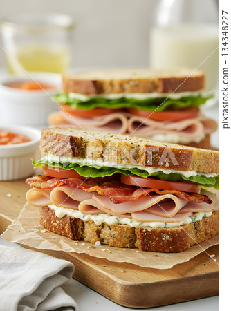 Stacked Deli Meat Sandwich on Whole Grain Bread 134348227