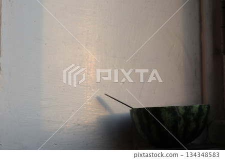 The eaten half of a watermelon on the veranda. 134348583