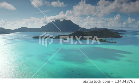 Captivating aerial view of Bora Bora, showcasing mount Otemanu, a crystal-clear turquoise lagoon, and luxurious overwater bungalows in a tropical paradise Captivating aerial view of Bora Bora, showcasing mount Otemanu, a crystal-clear turquoise lagoon, and luxurious overwater bungalows in a tropical paradise 134348765
