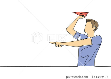 Single one line drawing a man in casual clothes stands and holds a paper airplane. Repeating childhood hobbies. Creativity. National Paper Airplane Day. Continuous line design graphic illustration 134349405