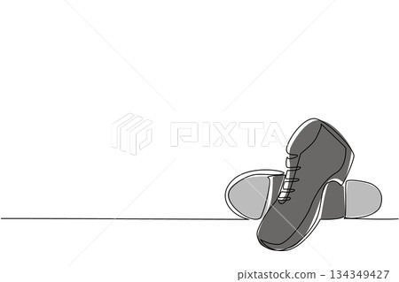 Single one line drawing tap dance shoes with a metal plate on the bottom. Shoes of men specifically for dancing. Made of leather. National Tap Dance Day. Continuous line design graphic illustration 134349427