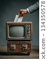 Ballot paper inserted into vintage television set 134350578