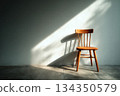 Empty wooden chair against wall with sunlight and shadow indoors 134350579