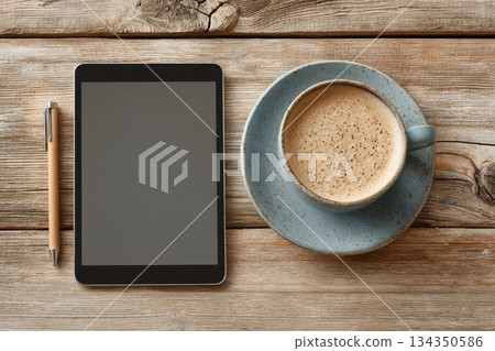 Digital tablet with stylus and cup of coffee on wooden table Digital tablet with stylus and cup of coffee on wooden table 134350586