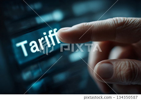 Finger pointing at tariff word on digital screen interface Finger pointing at tariff word on digital screen interface 134350587