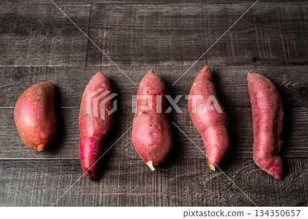 Sweet potatoes lined up side by side Sweet potatoes lined up side by side 134350657