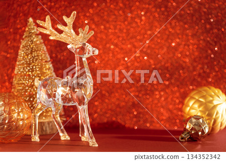 Crystal Reindeer with Golden Ornaments on Red Glitter Background 134352342