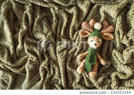 Crocheted Reindeer with Christmas Ornaments on Cozy Holiday Blanket Crocheted Reindeer with Christmas Ornaments on Cozy Holiday Blanket 134352344