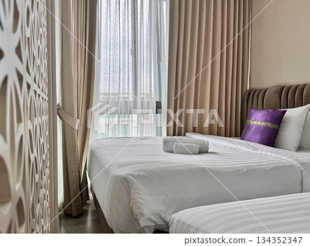 There is a double bed in the hotel room with neatly made bed linen and towels. High quality photo There is a double bed in the hotel room with neatly made bed linen and towels. High quality photo 134352347