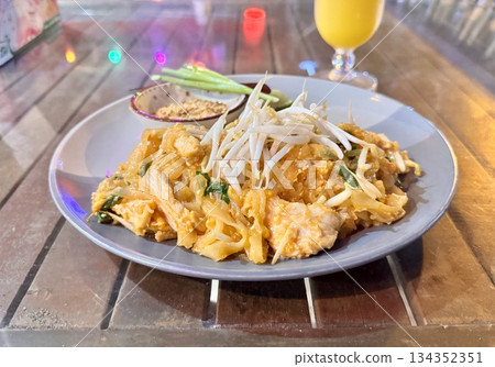 Delicious fresh Thai pad thai with chicken in an outdoor cafe. High quality photo 134352351