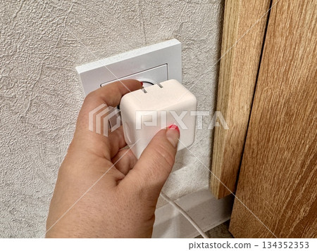 Charging a work laptop, charger. High quality photo 134352353