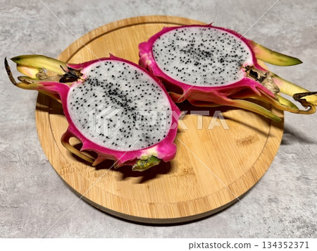 Dragon fruit, or pitahaya, is an exotic cactus fruit with bright pink, red, yellow skins and flesh with small black seeds.Photo Dragon fruit, or pitahaya, is an exotic cactus fruit with bright pink, red, yellow skins and flesh with small black seeds.Photo 134352371