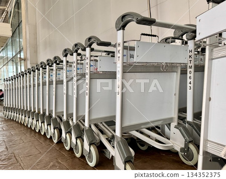 Trolleys for transporting luggage at the airport. High quality photo Trolleys for transporting luggage at the airport. High quality photo 134352375