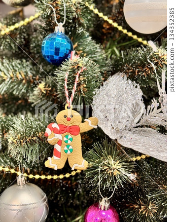 Bright Christmas Tree toys are hanging on the tree. High quality photo 134352385