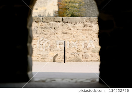 View through an ancient archway revealing a stone wall in daylight View through an ancient archway revealing a stone wall in daylight 134352756
