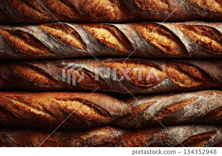 Freshly baked bread loaves stacked on a wooden table 134352948