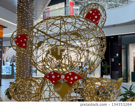 Christmas teddy bear light installation in shopping mall interior. Festive decoration, holiday joy, playful design, seasonal display and cheerful winter celebration atmosphere Christmas teddy bear light installation in shopping mall interior. Festive decoration, holiday joy, playful design, seasonal display and cheerful winter celebration atmosphere 134353264