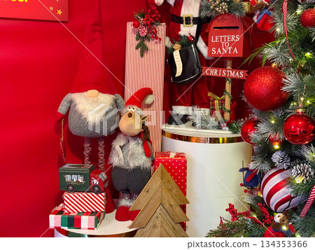 Christmas decor scene with gnomes, gifts and festive ornaments. Cozy holiday interior, winter celebration and playful seasonal styling. 134353366
