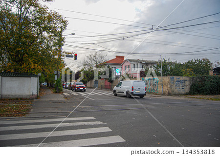 Urban street Intersection with crosswalk and traffic on an overcast day.  Urban street intersection with visible crosswalk and traffic lights. 134353818