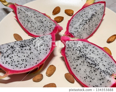 Dragon fruit, or pitahaya, is an exotic cactus fruit with bright pink, red, yellow skins and flesh with small black seeds. 134353888