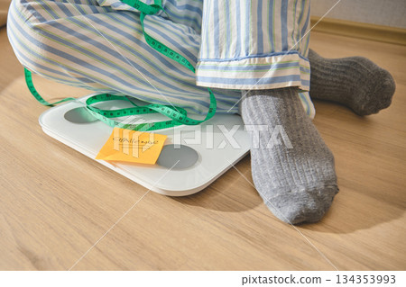 Person taking weight loss challenge for new year resolution 134353993