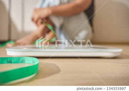 Person struggling with weight loss new year resolution 134353997