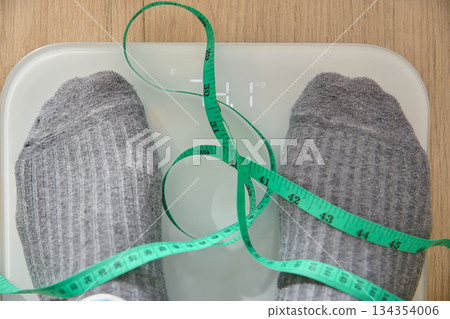 Feet on scale, measuring weight for new year resolution 134354006