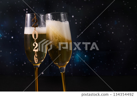 New Year Celebration. Two champagne glasses against a starry backdrop celebrating 2026. New Year Celebration. Two champagne glasses against a starry backdrop celebrating 2026. 134354492