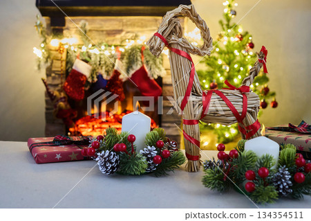 Julbock Christmas goat. A cozy Christmas setting with gifts, candles, a straw goat, 134354511