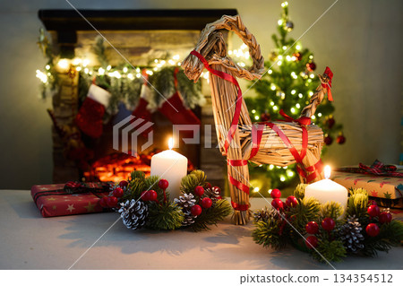 Julbock Christmas goat. A cozy Christmas setting with gifts, candles, a straw goat, 134354512