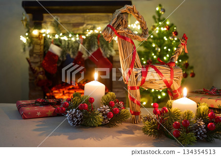Julbock Christmas goat. A cozy Christmas setting with gifts, candles, a straw goat, 134354513