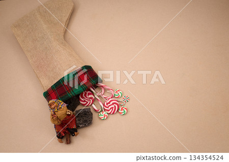 Epiphany Befana's stocking with sweet coal and candy. Italian Epiphany day. Epiphany Befana's stocking with sweet coal and candy. Italian Epiphany day. 134354524