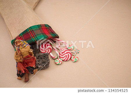 Epiphany Befana's stocking with sweet coal and candy. Italian Epiphany day. Epiphany Befana's stocking with sweet coal and candy. Italian Epiphany day. 134354525