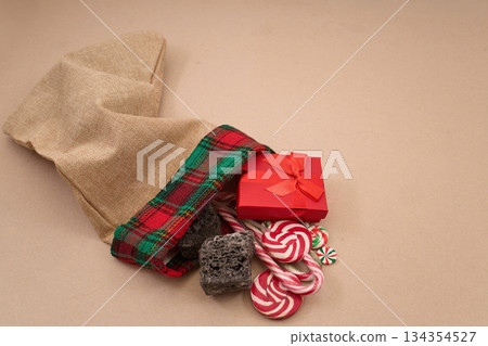 Epiphany Befana's stocking with sweet coal and candy. Italian Epiphany day. Epiphany Befana's stocking with sweet coal and candy. Italian Epiphany day. 134354527