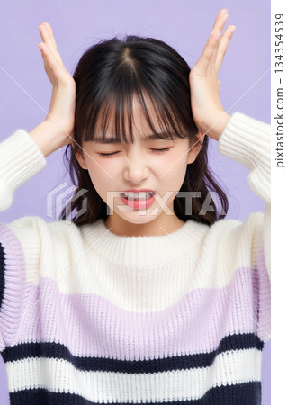A woman complaining of a headache 134354539