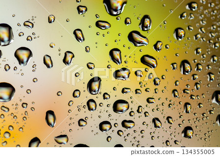 Beautiful multi-colored water droplets on a glass Beautiful multi-colored water droplets on a glass 134355005