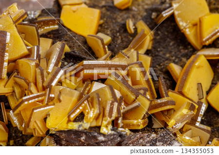 Macro mineral stone yellow Wulfenite on a white background 134355053