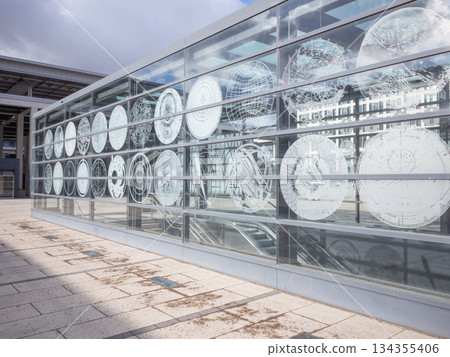[Germany] A circular modern art painted on the glass wall covering the underpass exit in front of Berlin Brandenburg International Airport 134355406